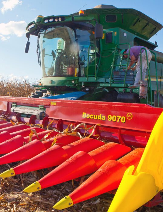 Woman standing on large agricultural machine