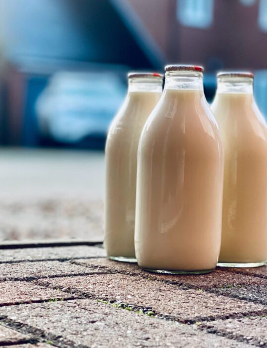 Three milk bottles on the ground