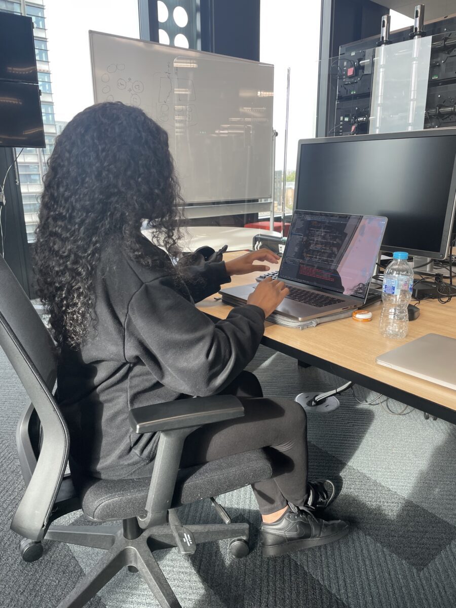 Esther at her desk working as a Software Developer
