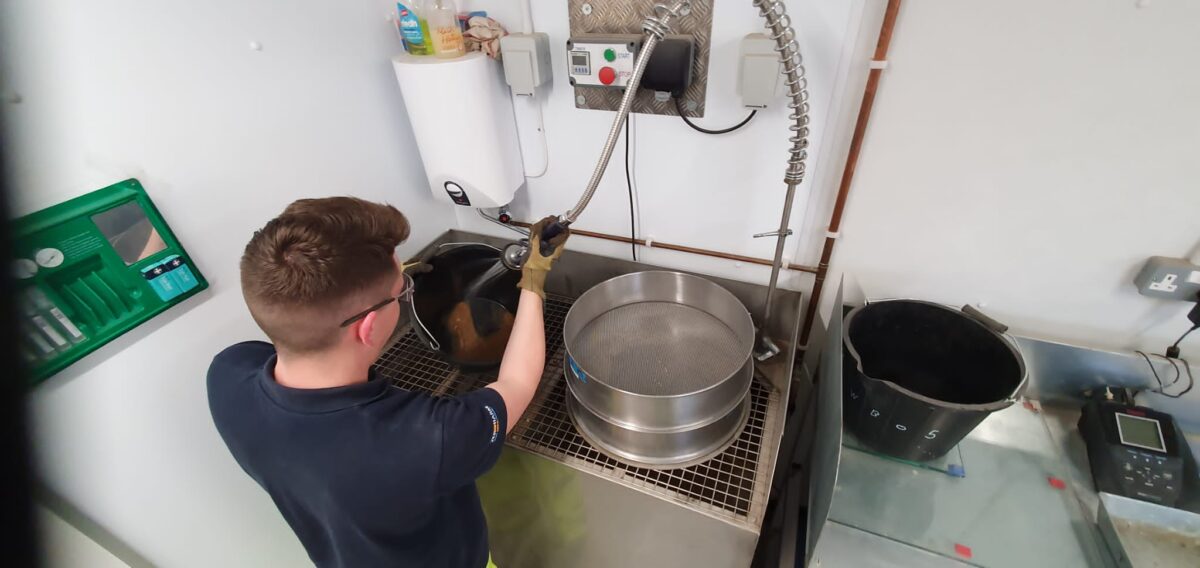 Thomas washing out concrete from buckets