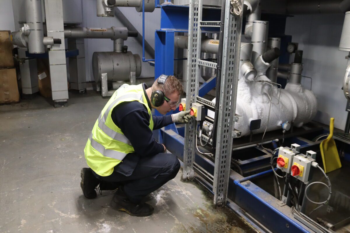 Sam Gills working on refrigeration equipment