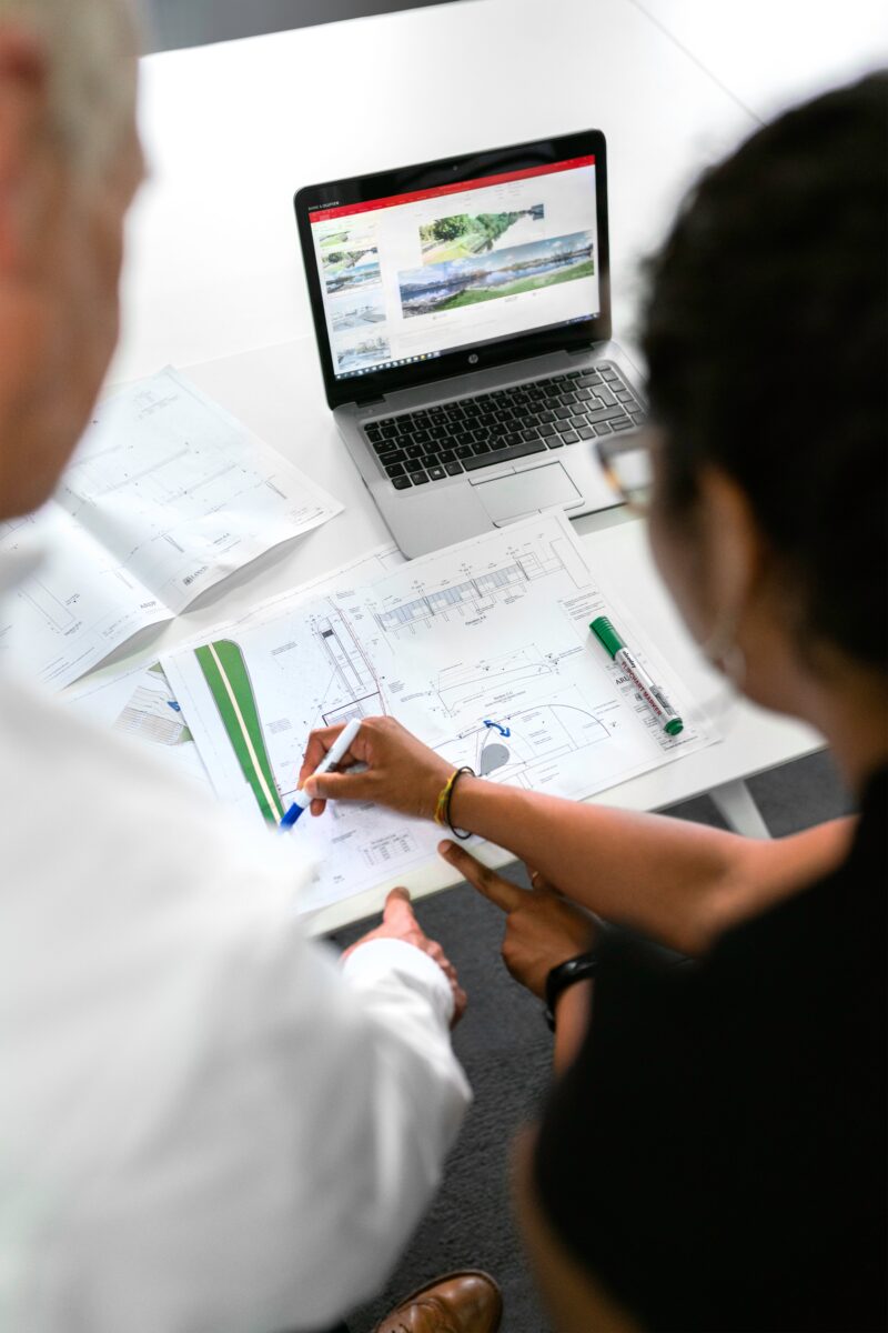 Man and woman looking at engineering drawings